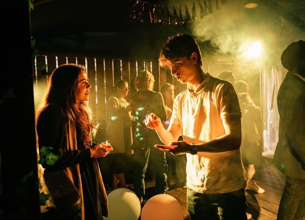 Two people talking at a party