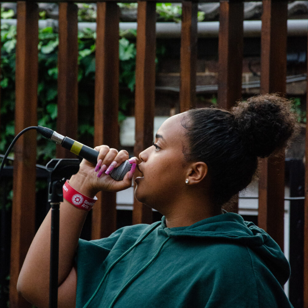 A woman singing into a microphone