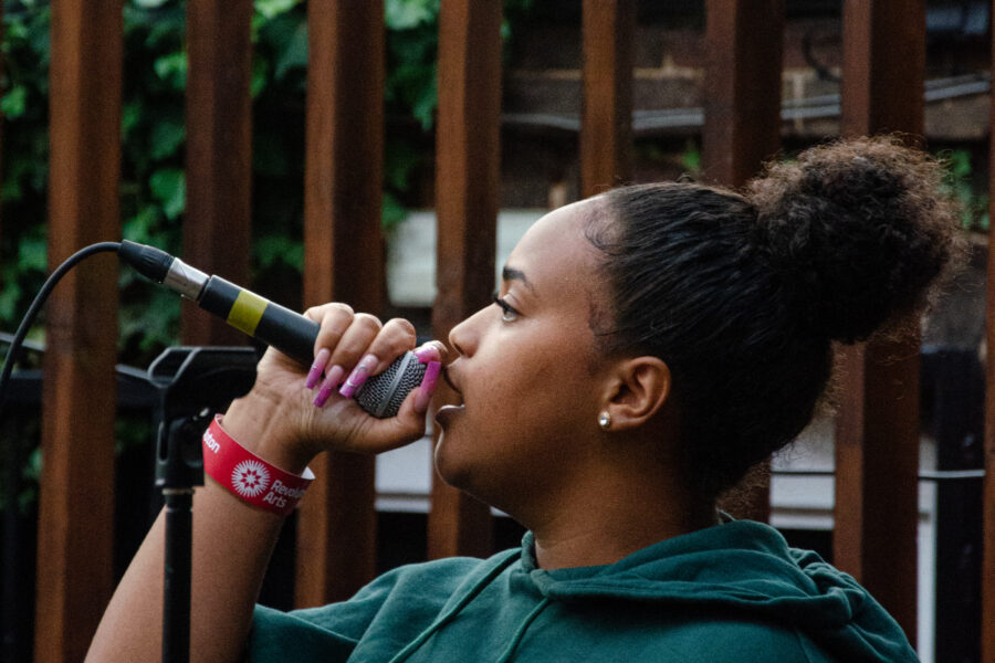 A woman singing into a microphone