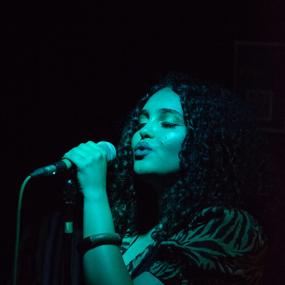 A woman singing into a microphone