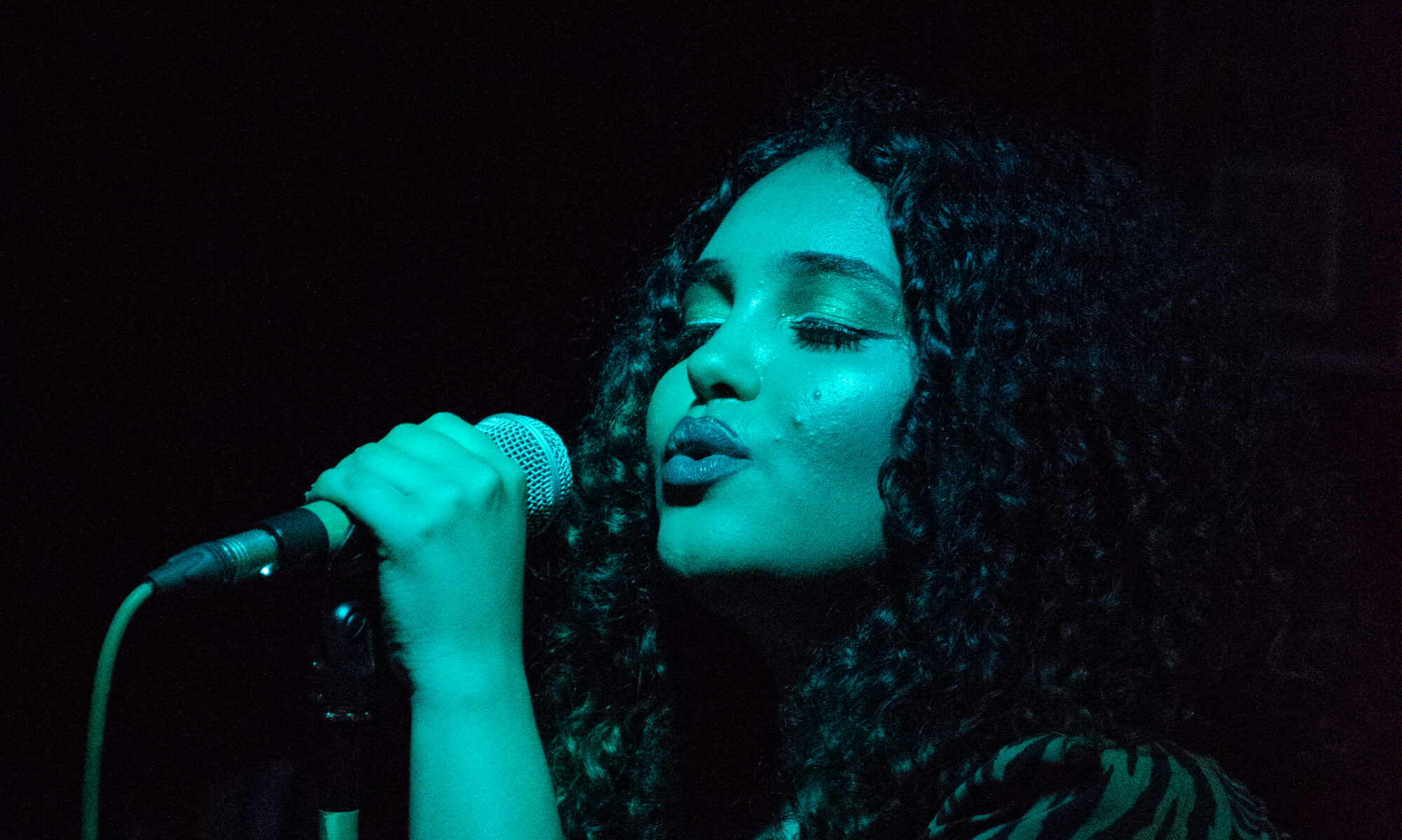 A woman singing into a microphone