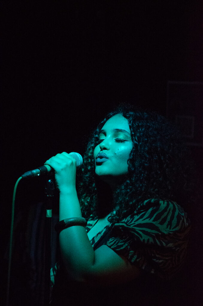 A woman singing into a microphone