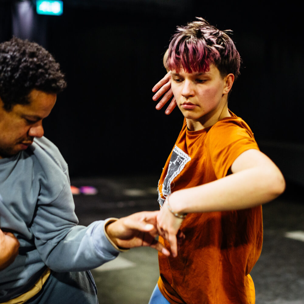 Two people dancing in a studio