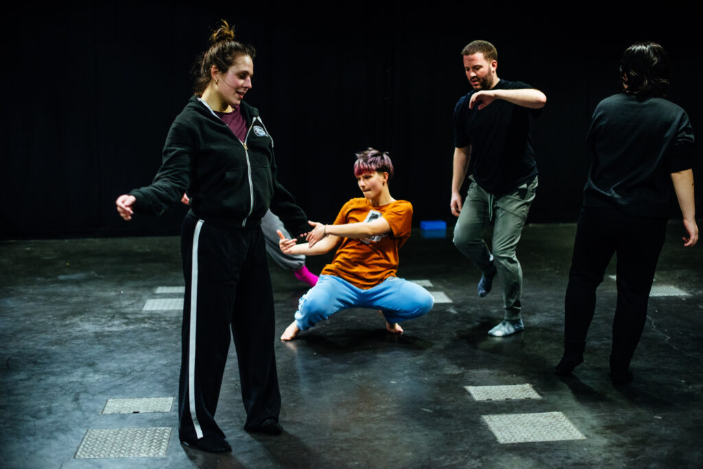 A group of people dancing in a studio