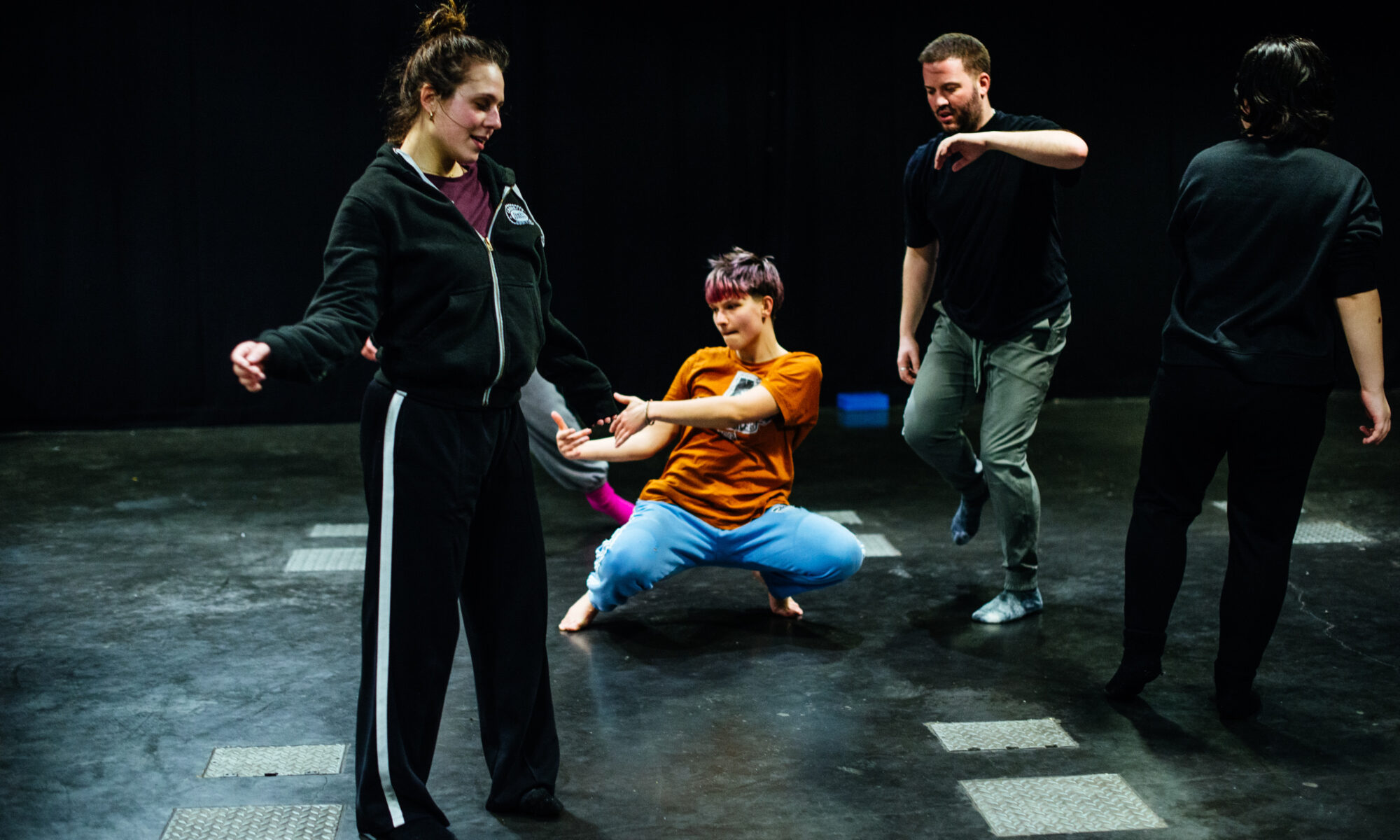 A group of people dancing in a studio