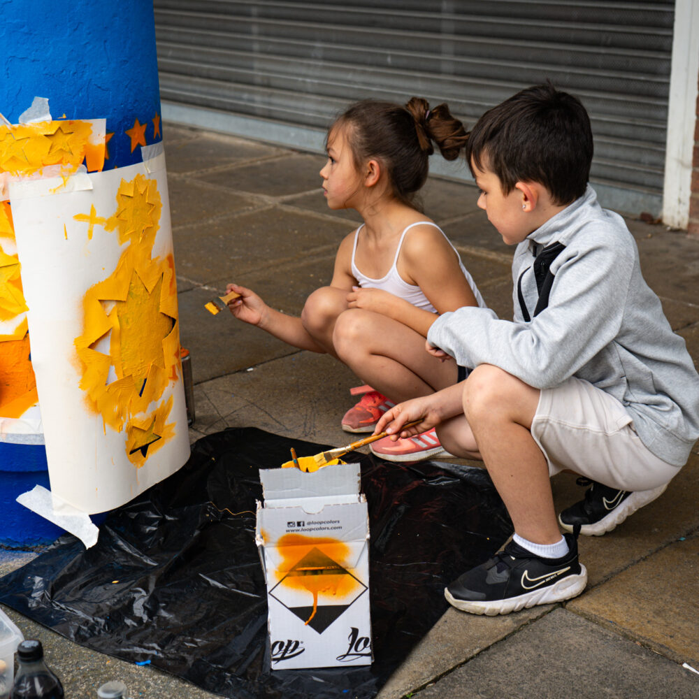Two children painting outside