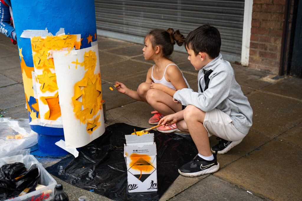 Two children painting outside