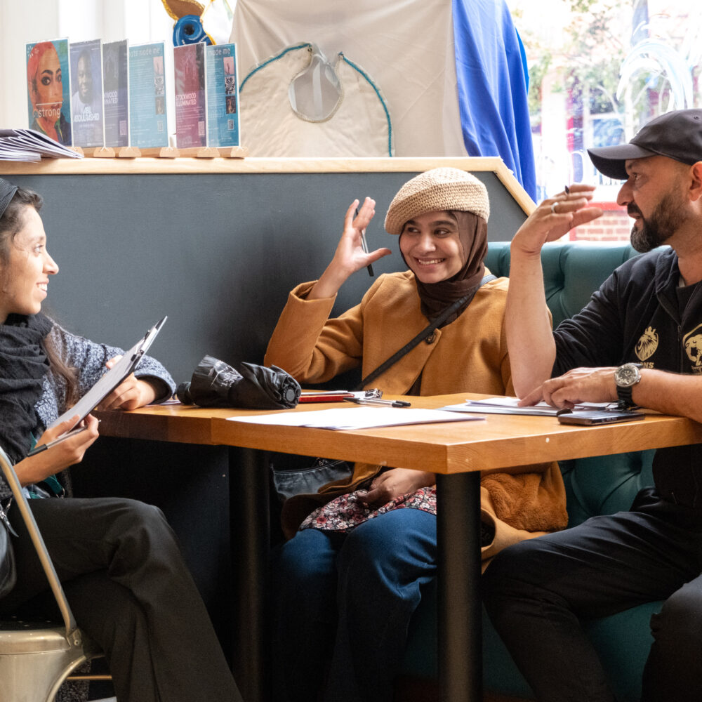 Three people talking at a table
