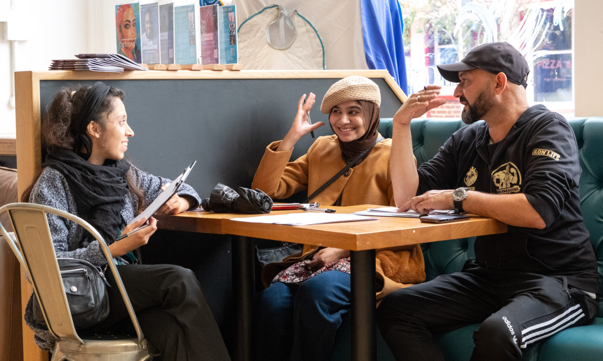 Three people talking at a table