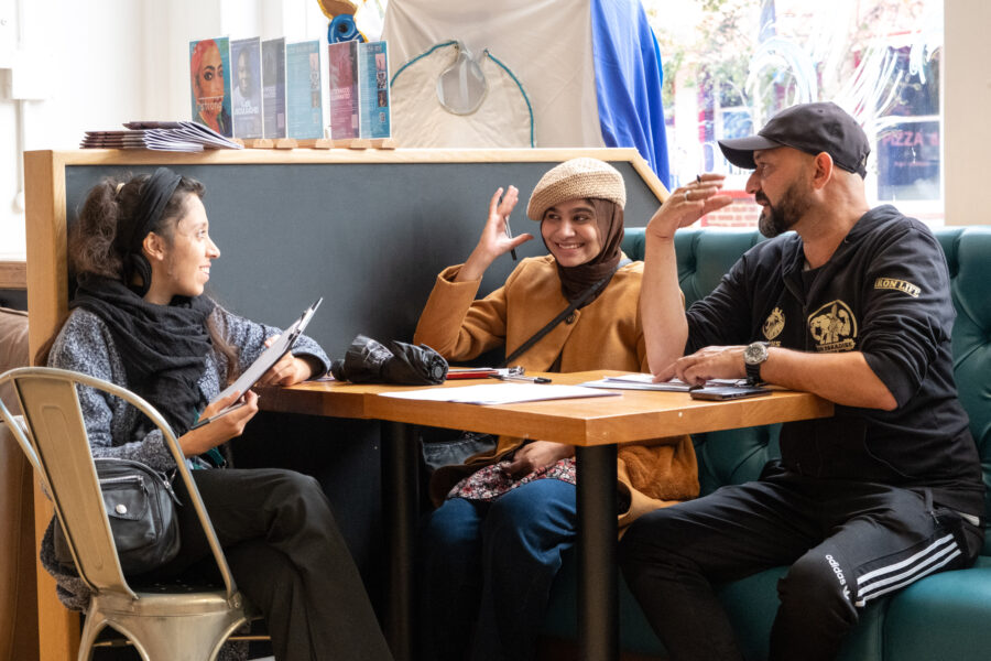 Three people talking at a table