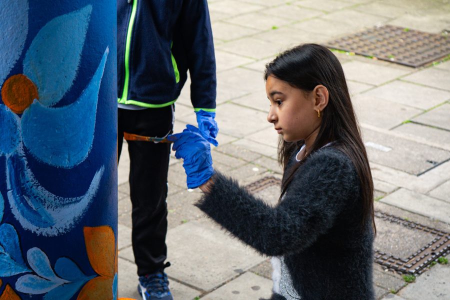 Child painting a pillar