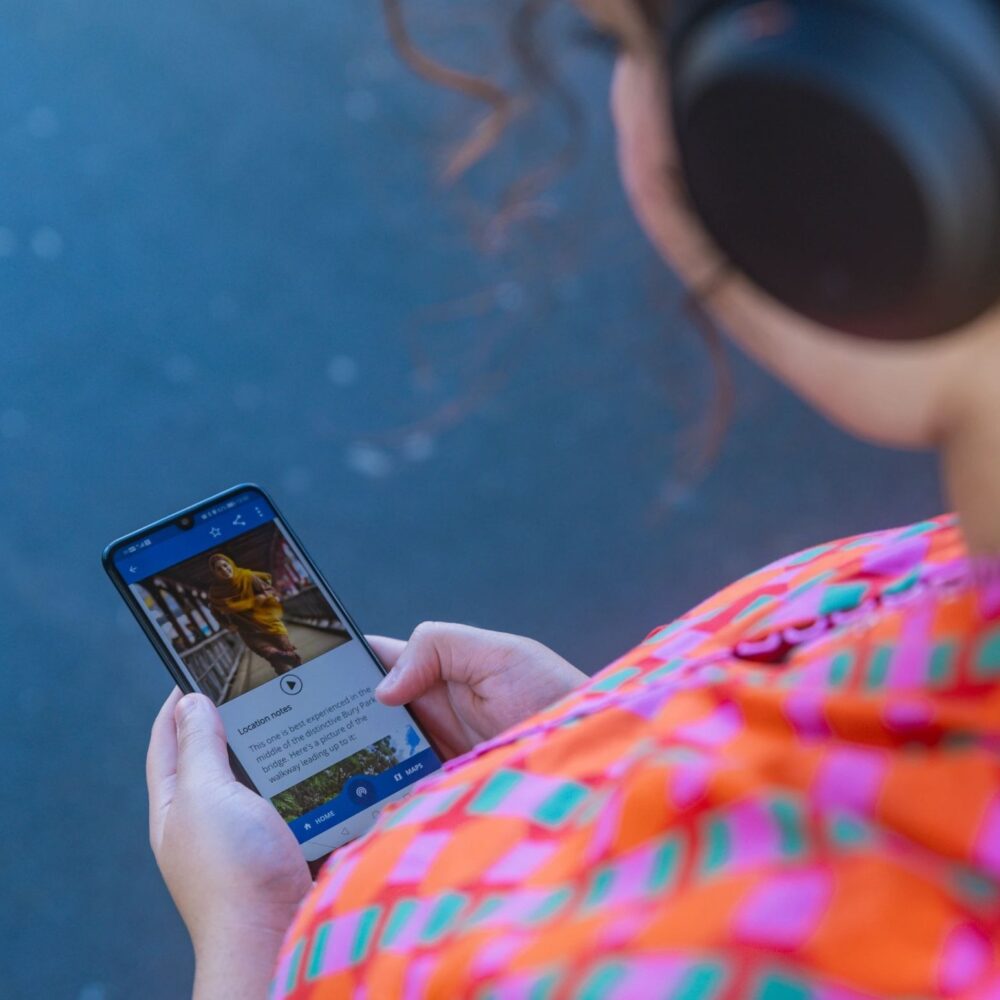 Woman wearing headphones listening to one of the stories