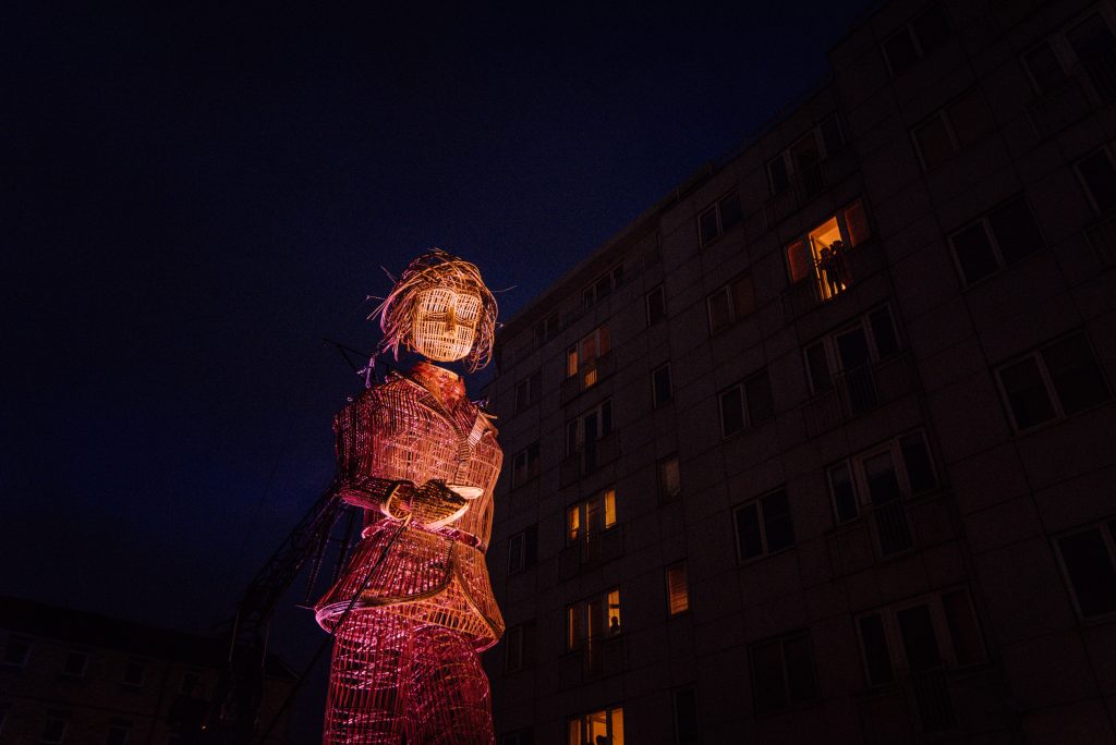 A giant wicker puppet at night time