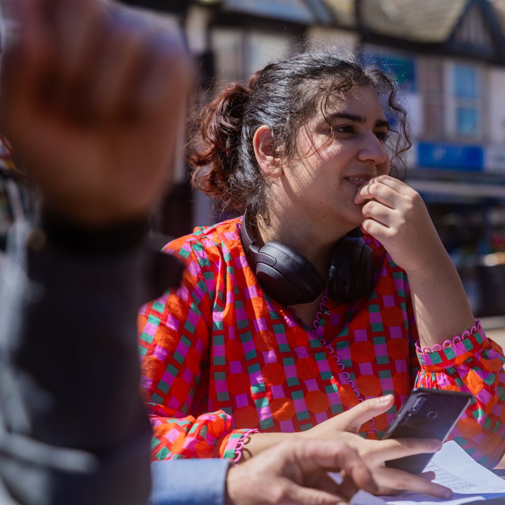 Woman sitting at a table outside