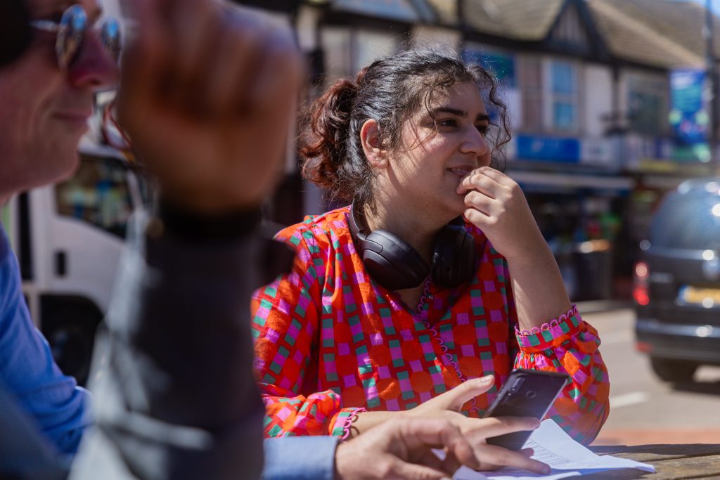 Woman sitting at a table outside