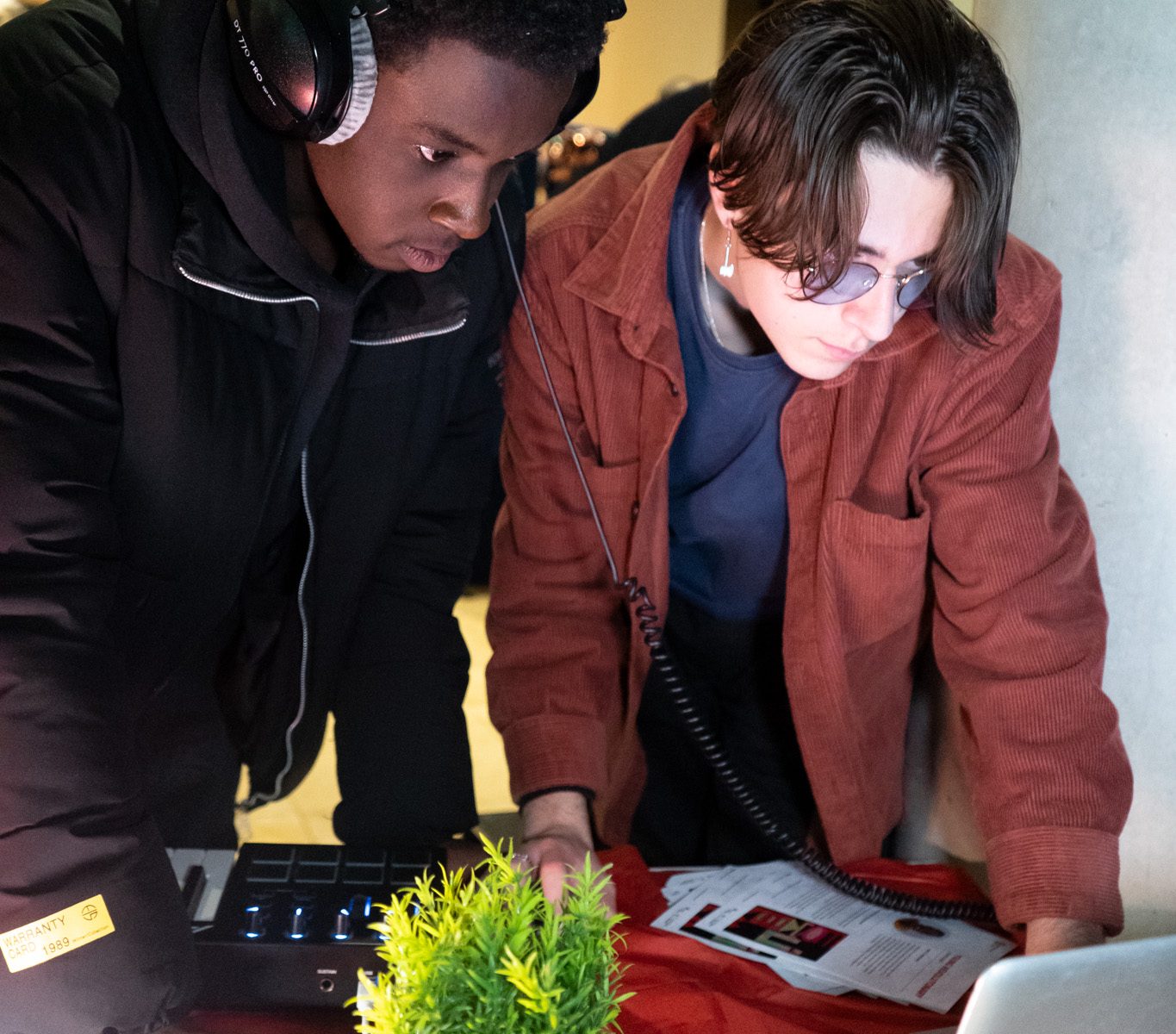 Two young people looking at a laptop