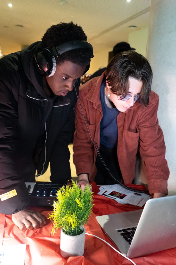 Two young people looking at a laptop