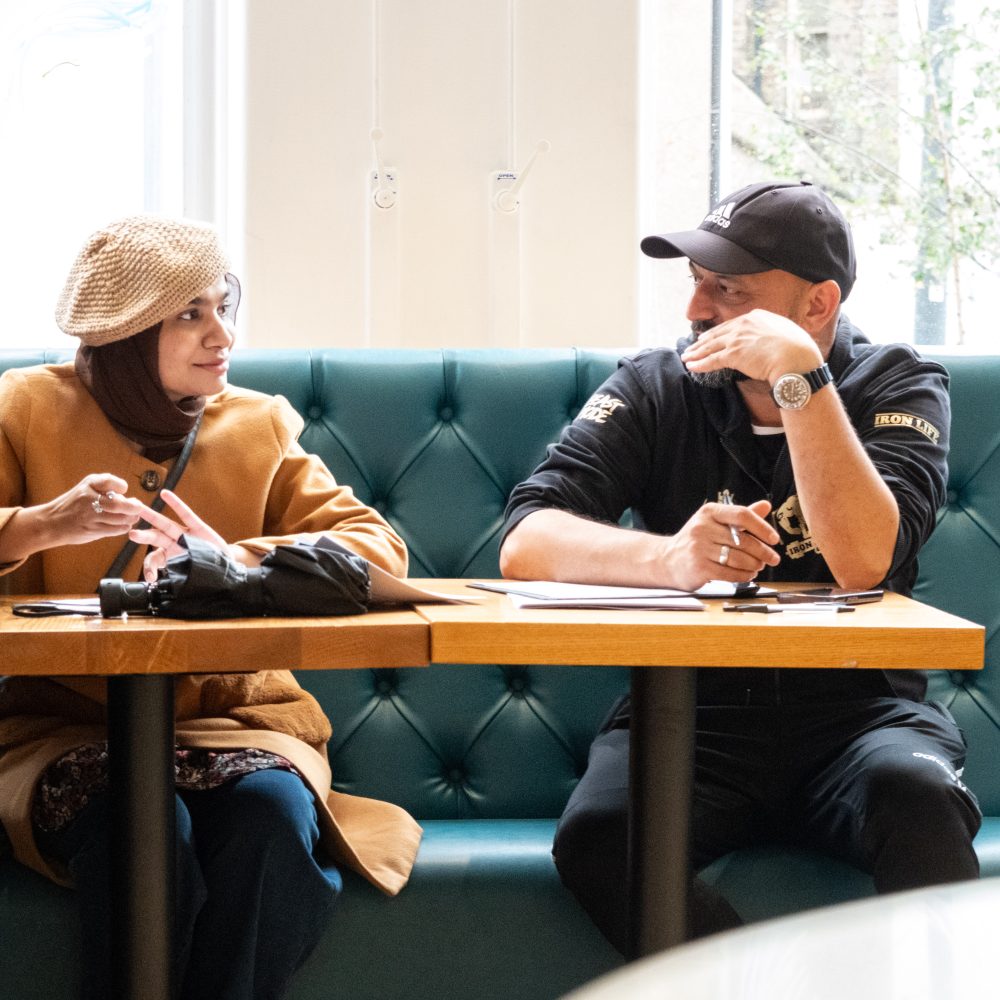 Two people sitting down in conversation