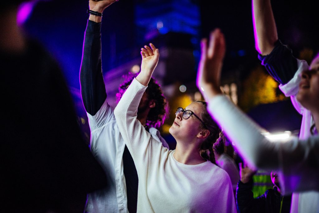 A young dancer looks at a raised hand