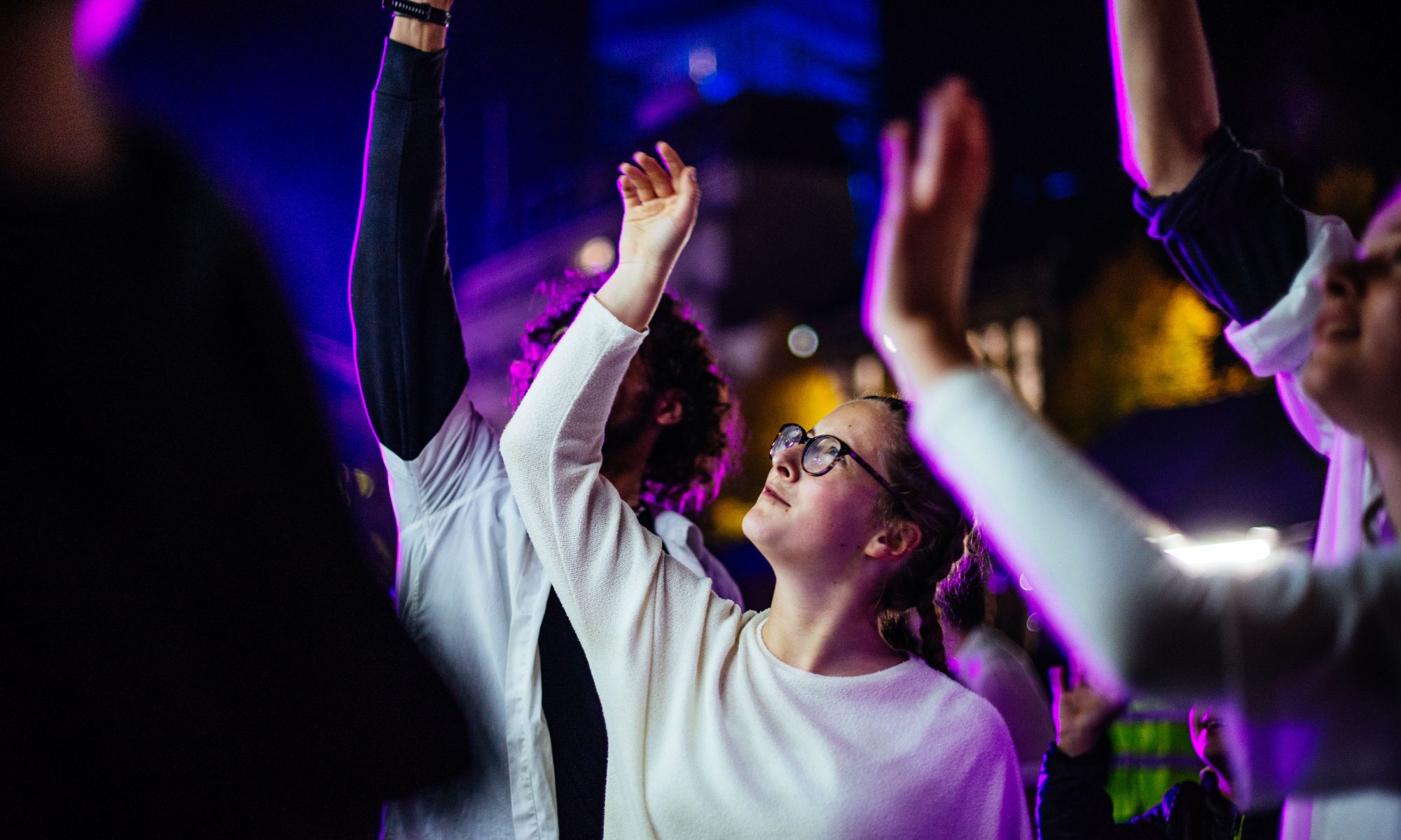 A young dancer looks at a raised hand